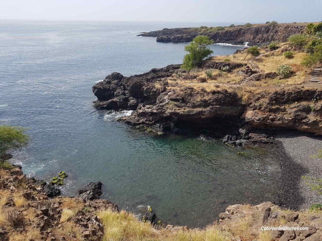 Serene view of Por do Sol Beach on Santiago Island, a pebble beach nestled amidst mountains and cliffs, with the turquoise Atlantic waters.