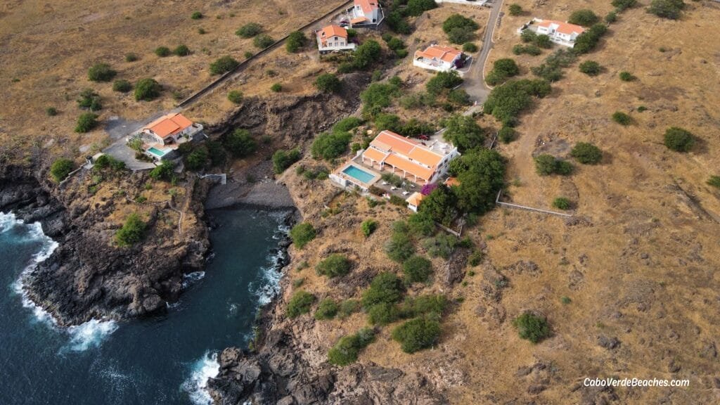 Serene view of Por do Sol Beach on Santiago Island, a pebble beach nestled amidst mountains and cliffs, with the turquoise Atlantic waters.