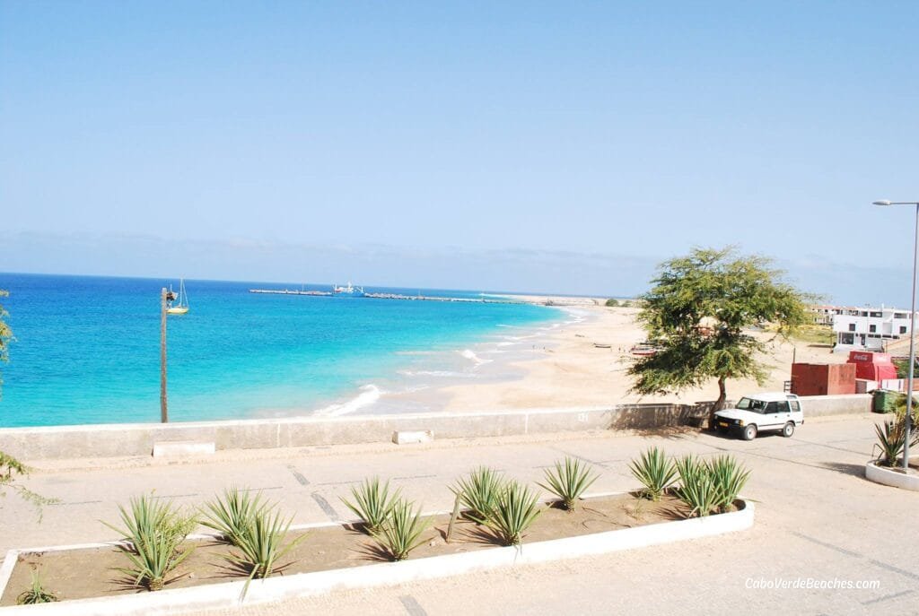 Panoramic view of Beach Bitche Rotcha on Maio Island, Cape Verde – white sandy shore stretching under a clear blue sky with gentle waves and local fishing boats.