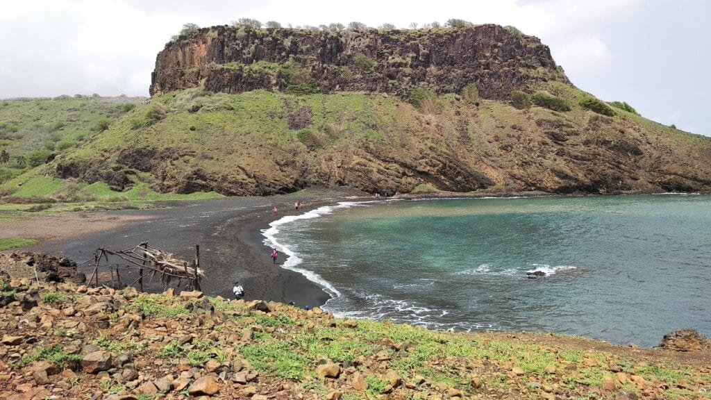 Golden sands and calm waters at Beach Praia de Mangue on Santiago Island, Cape Verde, surrounded by cliffs and untouched nature.
