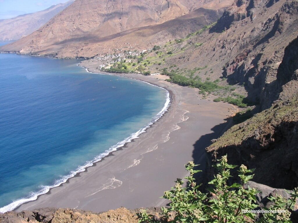 The Beach of Tarrafal de Monte Trigo in Santo Antão is a tranquil paradise with black volcanic sands, crystal-clear waters, and breathtaking mountain views.
