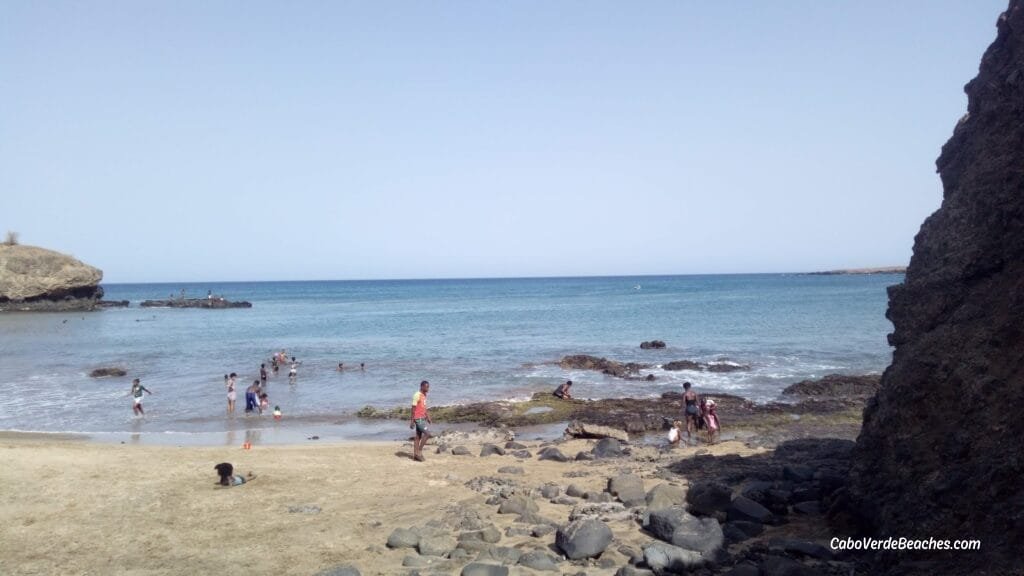 Panoramic view of São Francisco Beach on Santiago Island, Cape Verde, with golden sand, turquoise water, and peaceful scenery framed by cliffs.