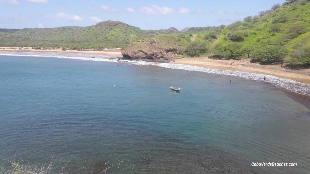 Panoramic view of São Francisco Beach on Santiago Island, Cape Verde, with golden sand, turquoise water, and peaceful scenery framed by cliffs.