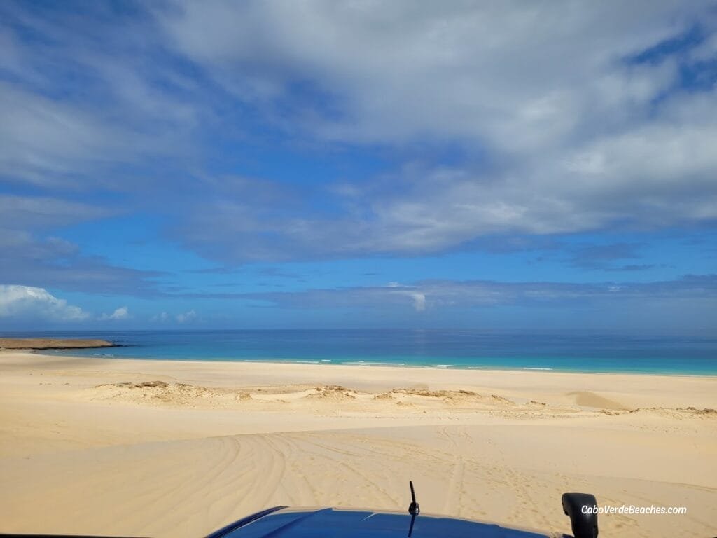 Golden dunes of Morro de Areia cascade into turquoise Atlantic waters beneath a 167 m sand hill, where Boa Vista’s desert meets the ocean in tranquil, protected beauty.