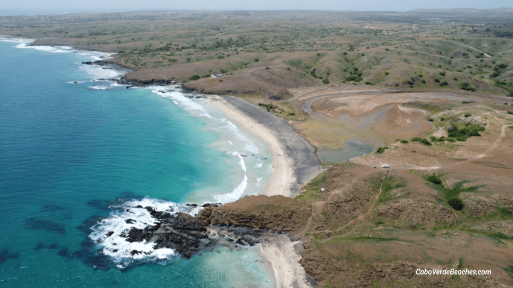 Ribeira Dom João Beach on Maio Island, Cape Verde – sweeping view of white and black sand, clear waters, and untouched natural surroundings under blue sky.