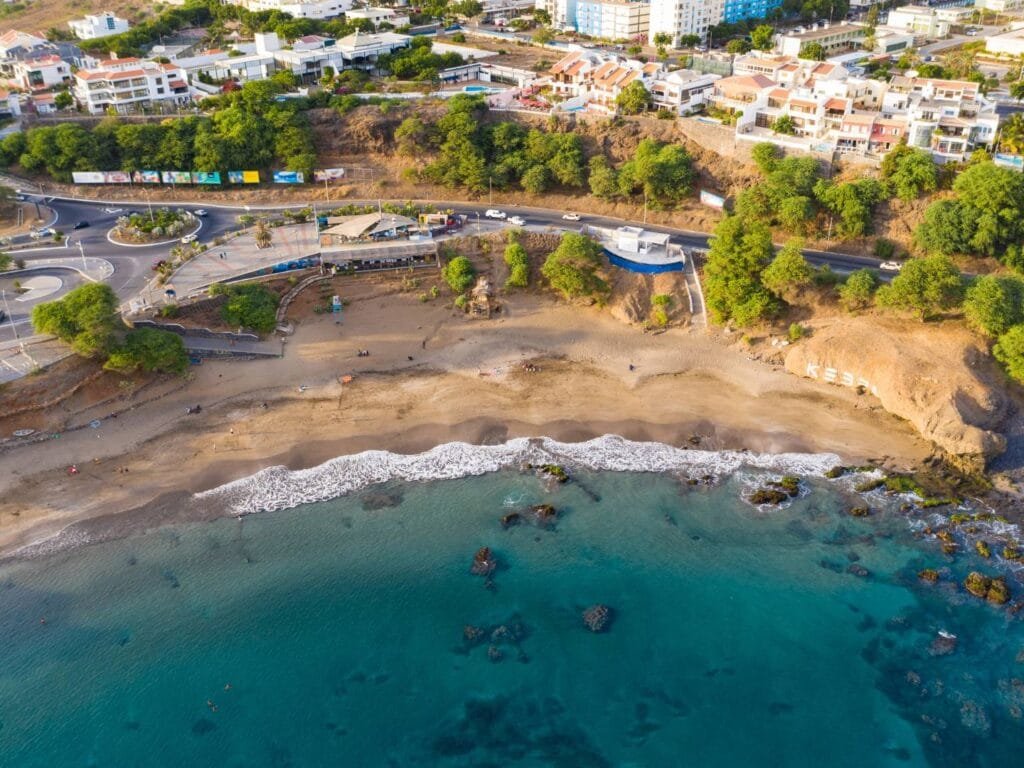 Kebra Kanela Beach in Praia, Santiago Island, Cape Verde – a peaceful beach surrounded by black volcanic sand, coastal rocks, and calm waters.