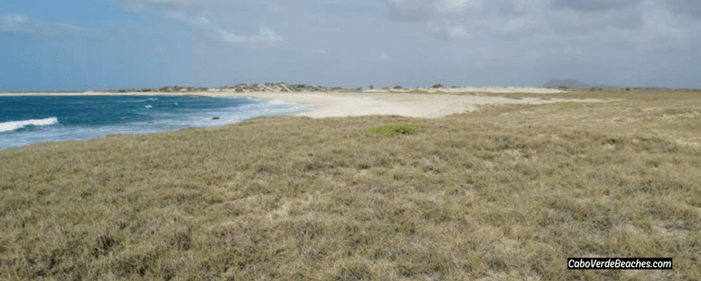 Scenic view of Cadjetinha de Morrinho Beach in Cape Verde, a secluded white-sand beach nestled behind dunes, with calm shallow waters and untouched natural beauty—an ideal retreat for peaceful swimming, wildlife watching, and connecting with nature.