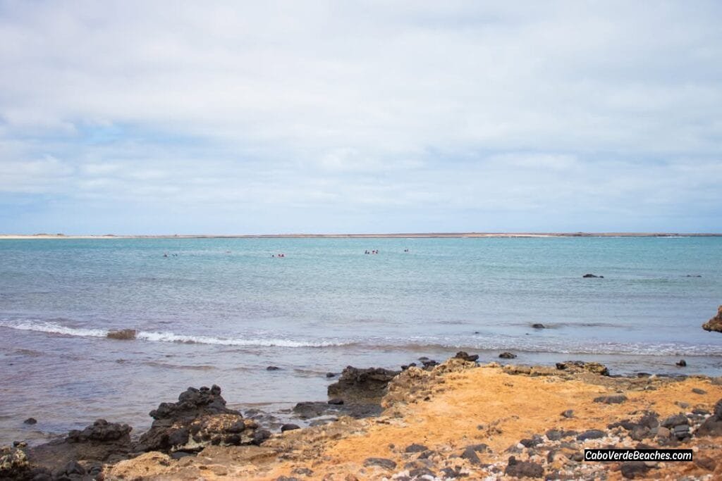 Tranquil Porto Cais Beach in Cape Verde, with its semicircular bay and colorful fishing boats.