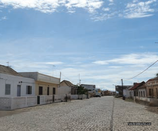Quiet cobbled street lined with traditional houses in Morro town, near Praias da Salina e Bancona, Maio Island, Cape Verde.