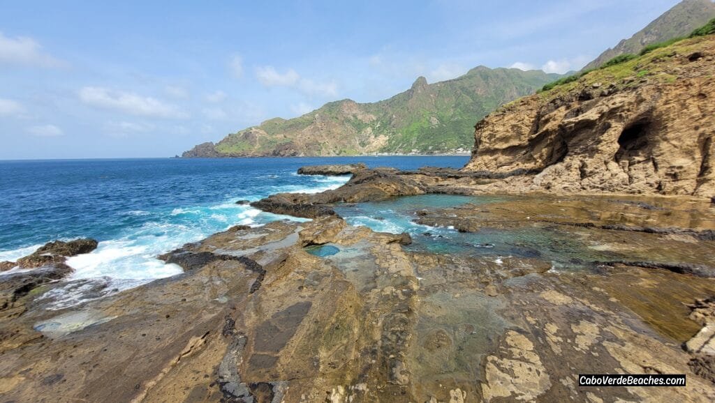 A breathtaking view of Piscina Natural Faja De Agua in Cape Verde, with turquoise waters surrounded by dark volcanic rocks.