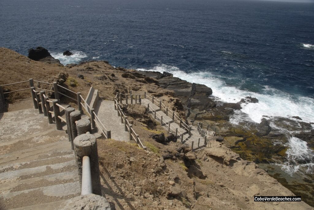 A breathtaking view of Piscina Natural Faja De Agua in Cape Verde, with turquoise waters surrounded by dark volcanic rocks.