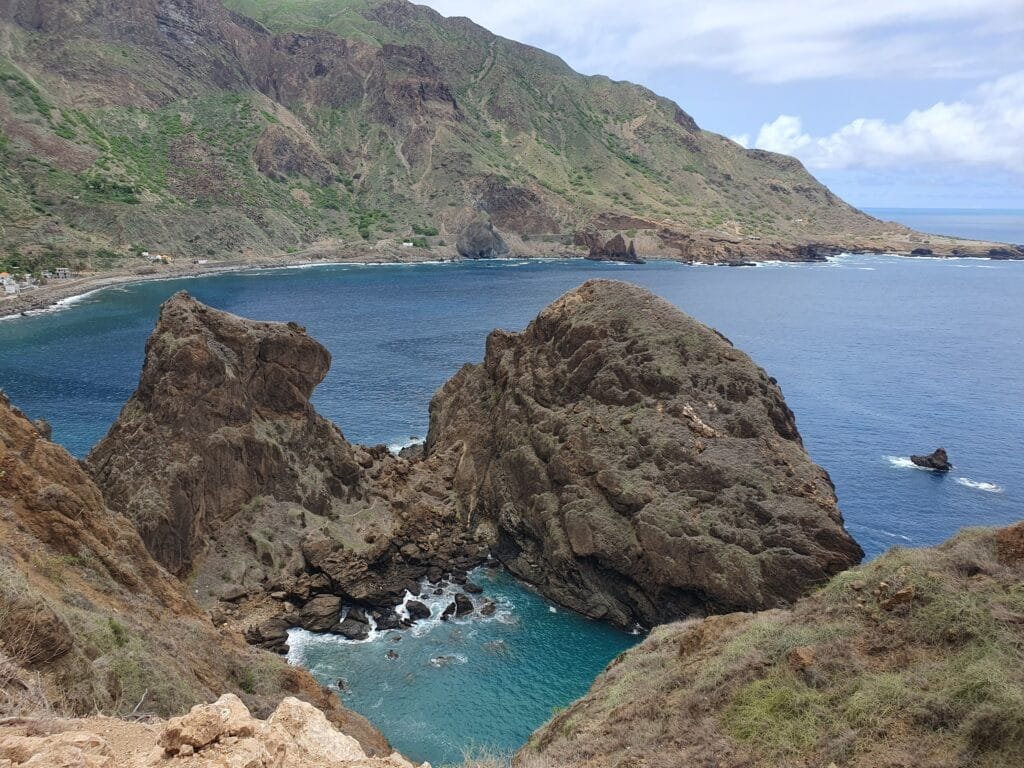 A breathtaking view of Piscina Natural Faja De Agua in Cape Verde, with turquoise waters surrounded by dark volcanic rocks.