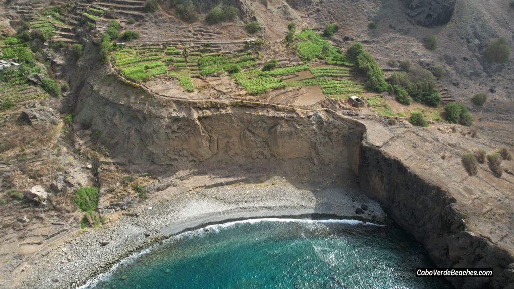 Panoramic view of Sorno Beach in Cape Verde featuring golden sands, turquoise waters, and scenic hills in the background under a sunny sky.