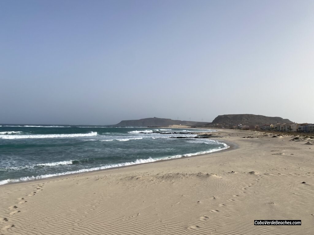 Stunning view of the golden sand and calm, clear turquoise water at Cruz Beach, Boa Vista, near Sal Rei, Cape Verde.
