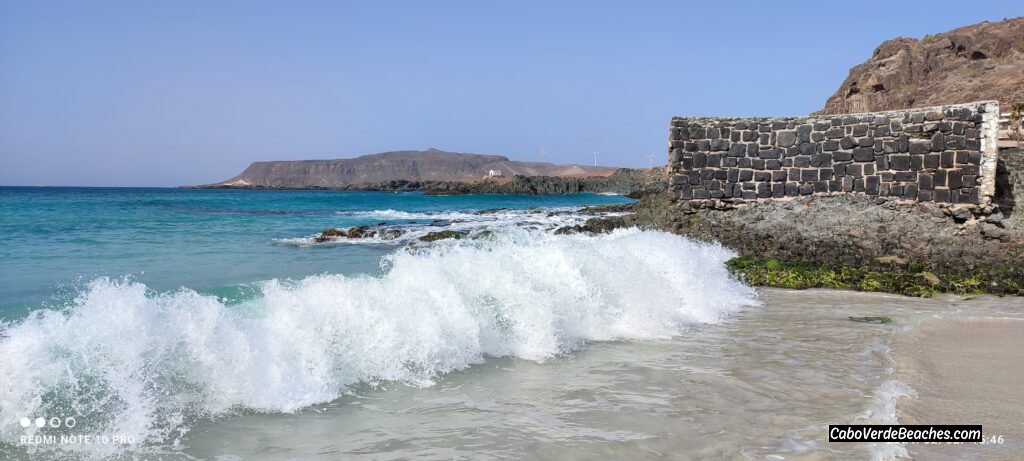 Stunning view of the golden sand and calm, clear turquoise water at Cruz Beach, Boa Vista, near Sal Rei, Cape Verde.
