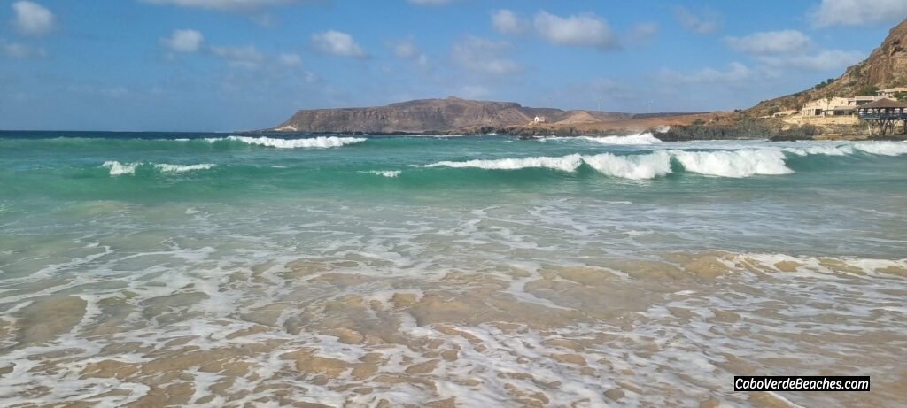 Stunning view of the golden sand and calm, clear turquoise water at Cruz Beach, Boa Vista, near Sal Rei, Cape Verde.