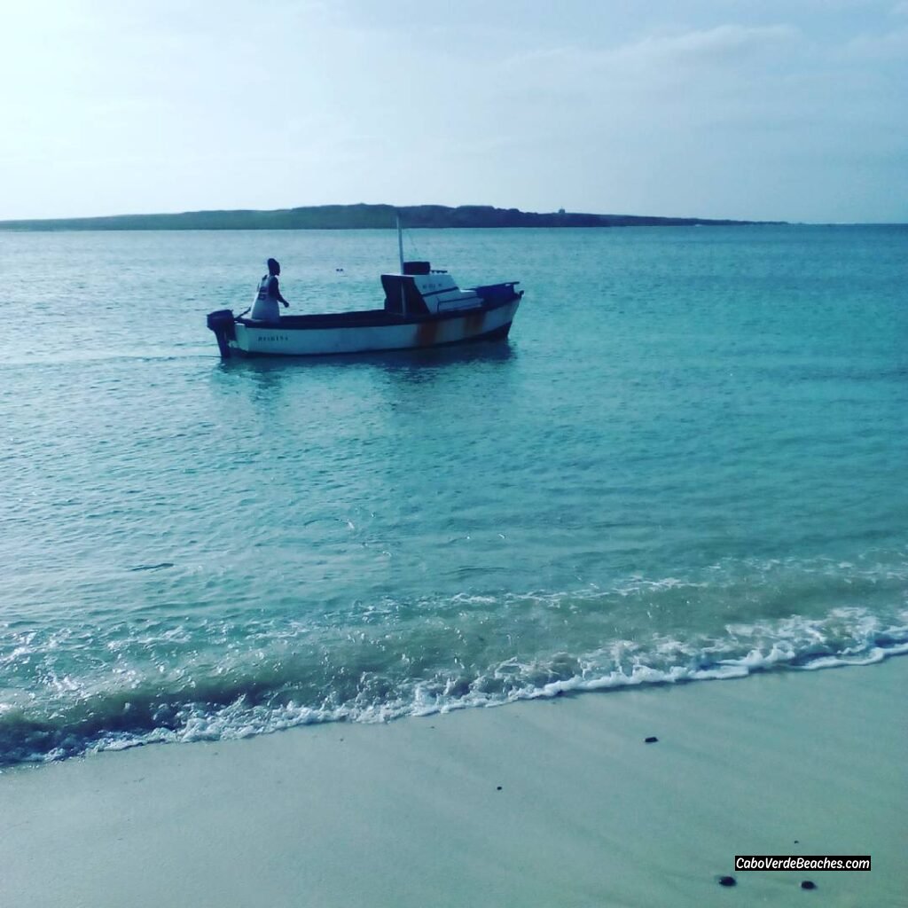 Local fishermen's boats returning to shore at Praia Diante, showcasing the cultural charm of this tranquil beach in Sal-Rei
